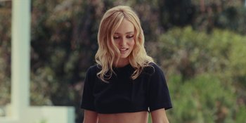 Movie still from “The Idol” (2023), directed by Sam Levinson – A woman with blonde hair wearing a black shirt; Medium shot, Low angle