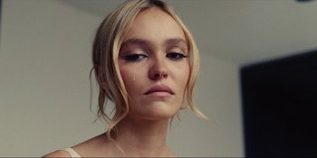 Movie still from “The Idol” (2023), directed by Sam Levinson – A person with long hair; Close Up shot, Low angle