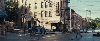 Movie still from “Bridge of Spies” (2015), directed by Steven Spielberg – A group of people standing on the side of a road; Extreme Wide shot, High angle