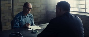 Movie still from “Bridge of Spies” (2015), directed by Steven Spielberg – Two men sitting at a table with papers in front of them; Medium shot, Over the shoulder angle