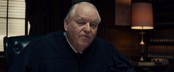 Movie still from “Bridge of Spies” (2015), directed by Steven Spielberg – An older man wearing a black robe and a white shirt; Close Up shot, Over the shoulder angle