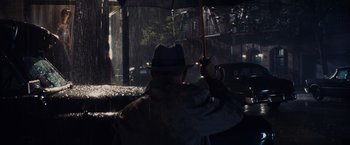 Movie still from “Bridge of Spies” (2015), directed by Steven Spielberg – A man with a hat and umbrella in the rain; Medium shot, High angle