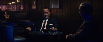 Movie still from “Bridge of Spies” (2015), directed by Steven Spielberg – A man sitting at a table with a bowl of food; Medium shot, Over the shoulder angle