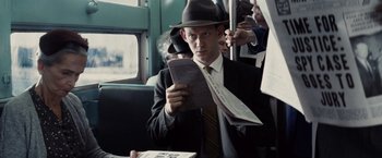 Movie still from “Bridge of Spies” (2015), directed by Steven Spielberg – A man in a suit and a hat on a bus; Close Up shot, Over the shoulder angle