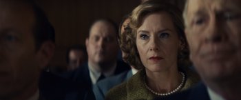 Movie still from “Bridge of Spies” (2015), directed by Steven Spielberg – An older woman in a brown coat and a pearl necklace; Close Up shot, Low angle
