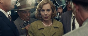 Movie still from “Bridge of Spies” (2015), directed by Steven Spielberg – An older woman in a yellow coat and a man in a suit; Close Up shot, Over the shoulder angle