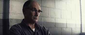 Movie still from “Bridge of Spies” (2015), directed by Steven Spielberg – An older man wearing glasses and a black shirt; Close Up shot, Low angle