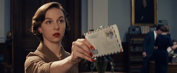 Movie still from “Bridge of Spies” (2015), directed by Steven Spielberg – A woman holding an envelope in front of her face; Close Up shot, Over the shoulder angle