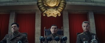 Movie still from “Bridge of Spies” (2015), directed by Steven Spielberg – A man sitting in a chair in front of a globe; Medium shot, Low angle