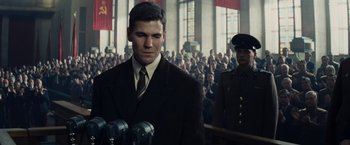 Movie still from “Bridge of Spies” (2015), directed by Steven Spielberg – A man standing in front of a crowd of people; Medium shot, Low angle