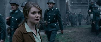 Movie still from “Bridge of Spies” (2015), directed by Steven Spielberg – A woman standing next to a man in a uniform; Close Up shot, Over the shoulder angle