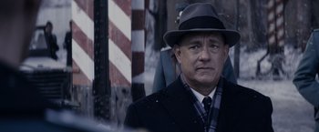 Movie still from “Bridge of Spies” (2015), directed by Steven Spielberg – A man in a hat and a suit; Close Up shot, Over the shoulder angle