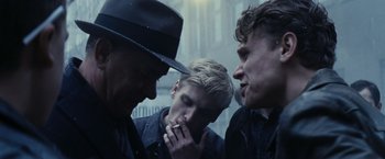 Movie still from “Bridge of Spies” (2015), directed by Steven Spielberg – A group of men standing next to each other on a city street; Close Up shot, Over the shoulder angle