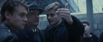 Movie still from “Bridge of Spies” (2015), directed by Steven Spielberg – Two men standing next to each other on a rainy day; Close Up shot, Over the shoulder angle