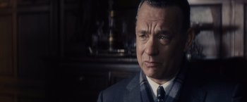 Movie still from “Bridge of Spies” (2015), directed by Steven Spielberg – An older man wearing a suit and tie; Close Up shot, Over the shoulder angle