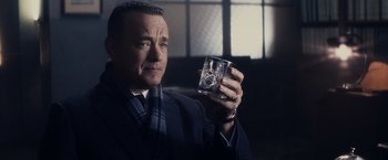 Movie still from “Bridge of Spies” (2015), directed by Steven Spielberg – A man holding a glass of water in his hand; Close Up shot, Over the shoulder angle