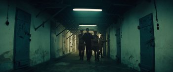 Movie still from “Bridge of Spies” (2015), directed by Steven Spielberg – A group of people walking down a dark hallway; Wide shot, Low angle