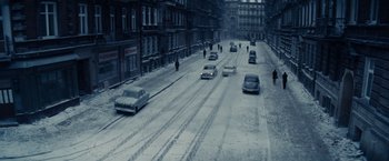 Movie still from “Bridge of Spies” (2015), directed by Steven Spielberg – Cars driving down a snowy street in a city; Extreme Wide shot, High angle