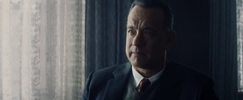 Movie still from “Bridge of Spies” (2015), directed by Steven Spielberg – An older man in a suit and tie looking off into the distance; Close Up shot, Over the shoulder angle