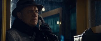 Movie still from “Bridge of Spies” (2015), directed by Steven Spielberg – A man in a hat and leather jacket talking on a phone; Close Up shot, Low angle