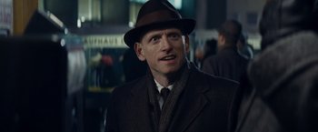 Movie still from “Bridge of Spies” (2015), directed by Steven Spielberg – A man wearing a suit and a hat; Close Up shot, Over the shoulder angle