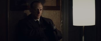 Movie still from “Bridge of Spies” (2015), directed by Steven Spielberg – A man in a suit and tie holding a cane; Close Up shot, Low angle