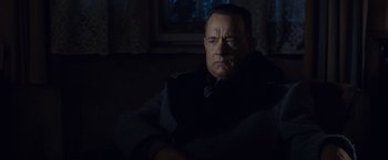 Movie still from “Bridge of Spies” (2015), directed by Steven Spielberg – A man sitting on a couch in a dark room; Close Up shot, Low angle