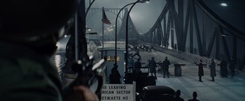 Movie still from “Bridge of Spies” (2015), directed by Steven Spielberg – A group of people standing on top of a bridge; Extreme Wide shot, High angle