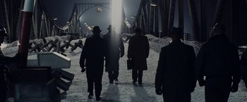 Movie still from “Bridge of Spies” (2015), directed by Steven Spielberg – A group of people walking across a bridge; Extreme Wide shot, Low angle