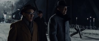 Movie still from “Bridge of Spies” (2015), directed by Steven Spielberg – A group of men walking down a street at night; Medium shot, Low angle