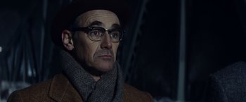 Movie still from “Bridge of Spies” (2015), directed by Steven Spielberg – An older man wearing glasses and a hat; Close Up shot, Low angle
