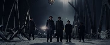 Movie still from “Bridge of Spies” (2015), directed by Steven Spielberg – A group of men standing on top of a snow covered ground; Wide shot, Low angle