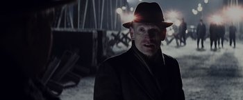 Movie still from “Bridge of Spies” (2015), directed by Steven Spielberg – A man wearing a hat and a suit; Close Up shot, Over the shoulder angle