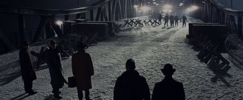 Movie still from “Bridge of Spies” (2015), directed by Steven Spielberg – A group of people standing on top of a snow covered slope; Extreme Wide shot, High angle