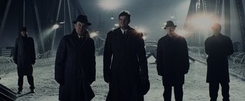 Movie still from “Bridge of Spies” (2015), directed by Steven Spielberg – A group of men walking down a street at night; Medium shot, Low angle