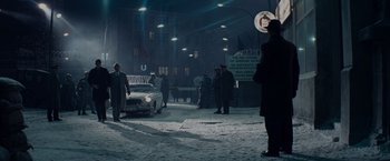 Movie still from “Bridge of Spies” (2015), directed by Steven Spielberg – A group of people standing around a car in the dark; Wide shot, Low angle