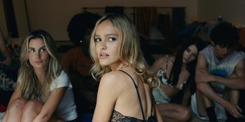 Movie still from “The Idol” (2023), directed by Sam Levinson – A beautiful young lady in a black dress; Close Up shot, High angle