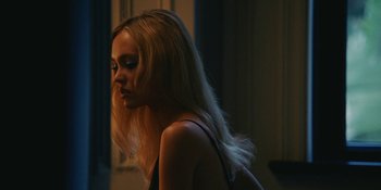 Movie still from “The Idol” (2023), directed by Sam Levinson – A beautiful young woman with long blonde hair; Close Up shot, Over the shoulder angle