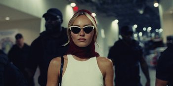 Movie still from “The Idol” (2023), directed by Sam Levinson – A woman wearing sunglasses and a red head scarf; Close Up shot, Low angle