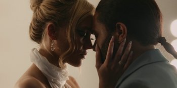 Movie still from “The Idol” (2023), directed by Sam Levinson – A man and a woman are looking into each others eyes; Close Up shot, Overhead angle