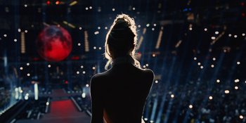 Movie still from “The Idol” (2023), directed by Sam Levinson – A woman standing in front of an audience at a concert; Wide shot, Low angle