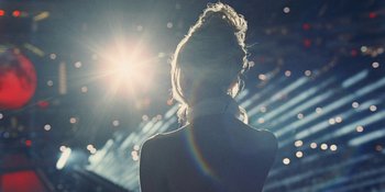 Movie still from “The Idol” (2023), directed by Sam Levinson – A woman standing in front of a stage with lights; Extreme Close Up shot, Low angle