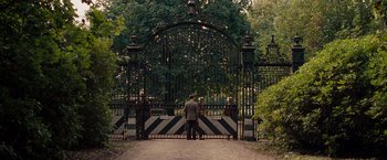 Movie still from “The Imitation Game” (2014), directed by Morten Tyldum – A man standing in front of an open gate; Extreme Wide shot, Over the shoulder angle