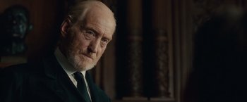 Movie still from “The Imitation Game” (2014), directed by Morten Tyldum – An old man with a beard and a white mustache; Close Up shot, Low angle