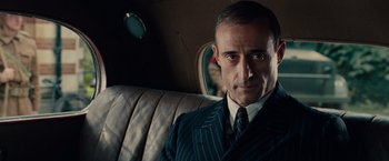 Movie still from “The Imitation Game” (2014), directed by Morten Tyldum – A person wearing a suit and tie; Close Up shot, Over the shoulder angle