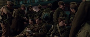 Movie still from “The Imitation Game” (2014), directed by Morten Tyldum – A group of men in uniform sitting next to each other; Medium shot, High angle