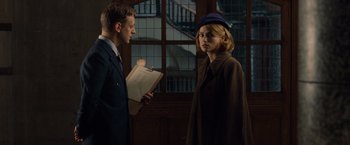 Movie still from “The Imitation Game” (2014), directed by Morten Tyldum – A man and a woman standing next to each other; Medium shot, Over the shoulder angle