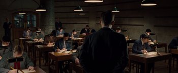 Movie still from “The Imitation Game” (2014), directed by Morten Tyldum – A group of people sitting at tables in a room; Wide shot, High angle