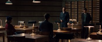 Movie still from “The Imitation Game” (2014), directed by Morten Tyldum – A man standing in front of a mirror in a room; Wide shot, Over the shoulder angle