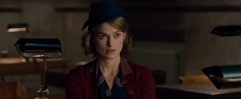 Movie still from “The Imitation Game” (2014), directed by Morten Tyldum – A woman with a blue hat is looking at the camera; Close Up shot, Over the shoulder angle